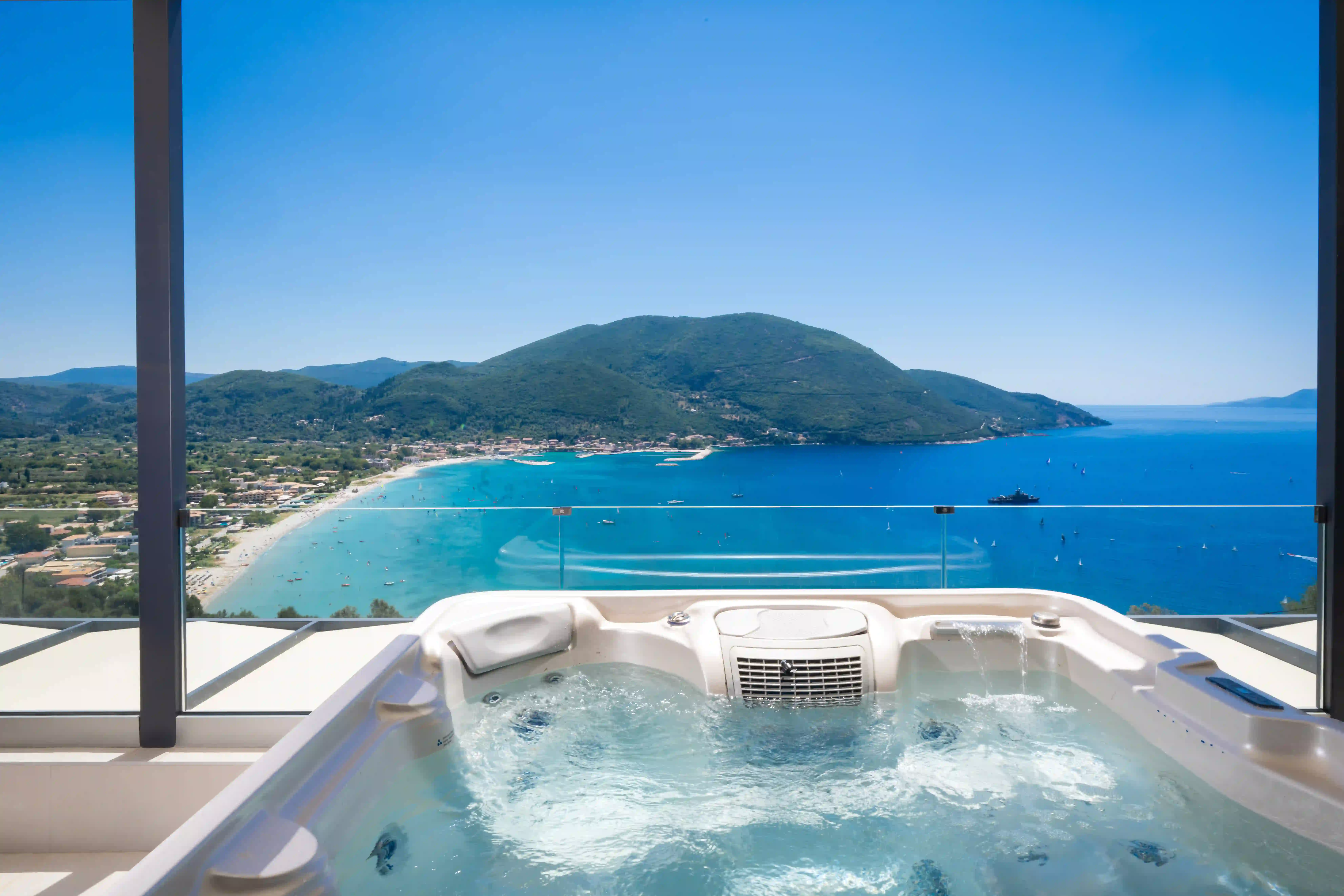 Private infinity pool and hot tub with Vasiliki Bay views at Azzura Villas